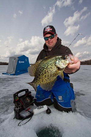 Ice angler holding crappie
