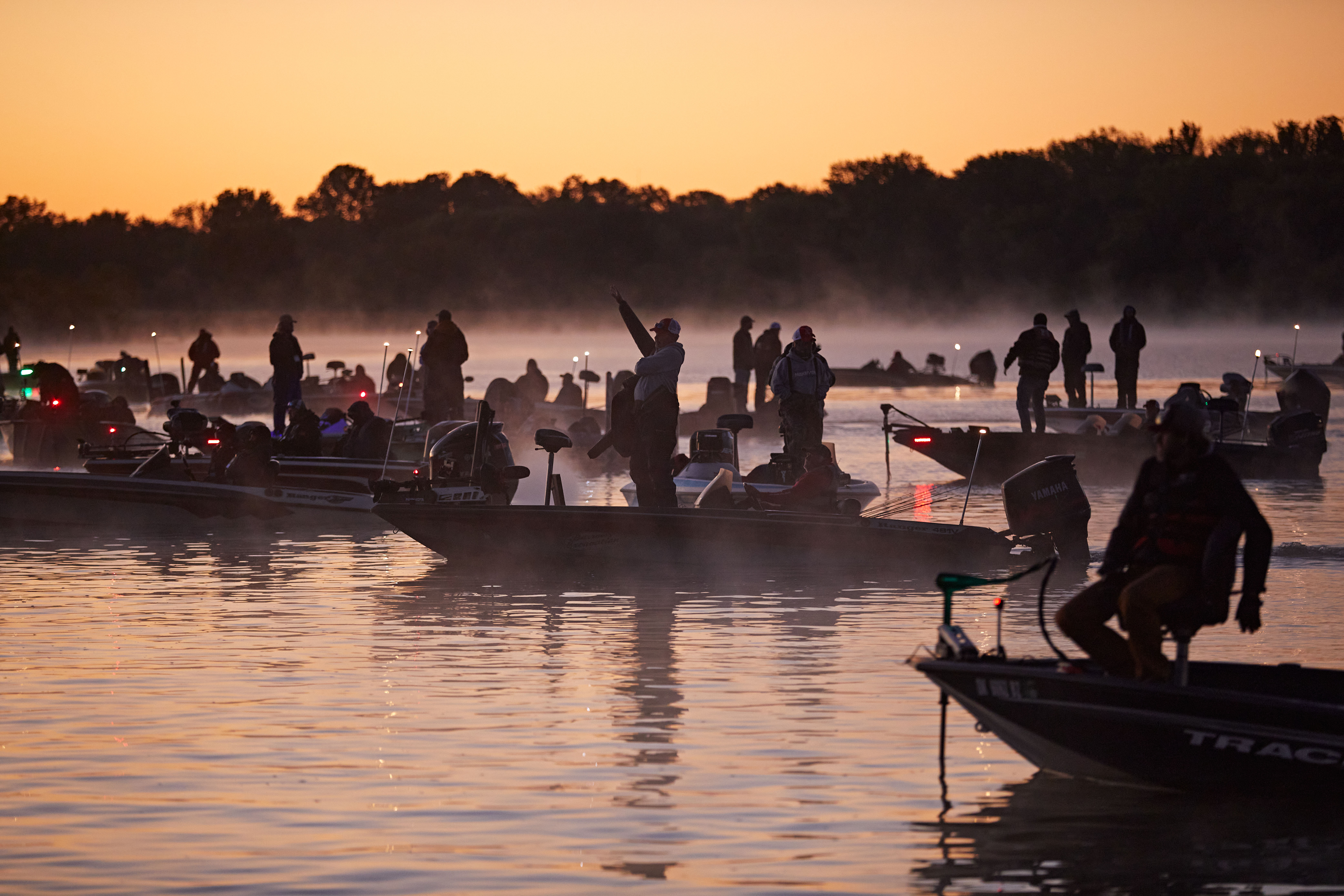 Tournament fishing anglers on lake at sunset