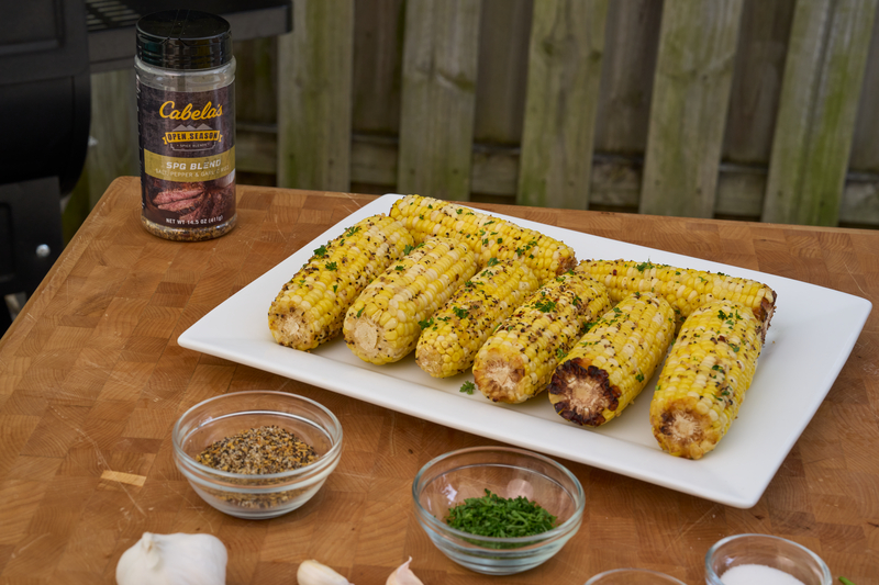 freshly cooked and seasoned traditional grilled corn on the cob