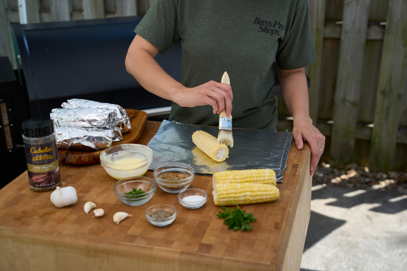 buttering fresh corn on the cob with butter