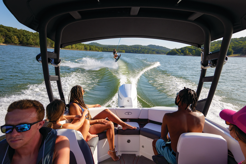 Group of boaters pulling wake boarder