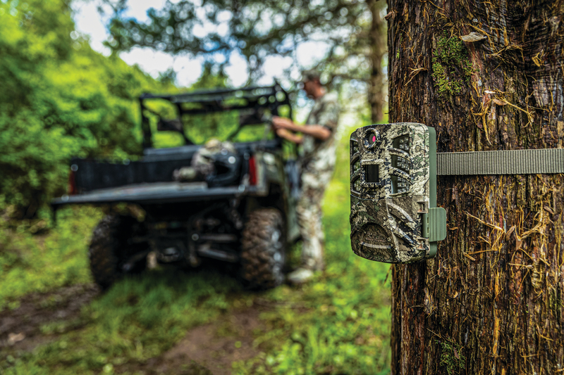 Cabela's Outfitter Gen 4 Black IR Trail Camera set up in woods
