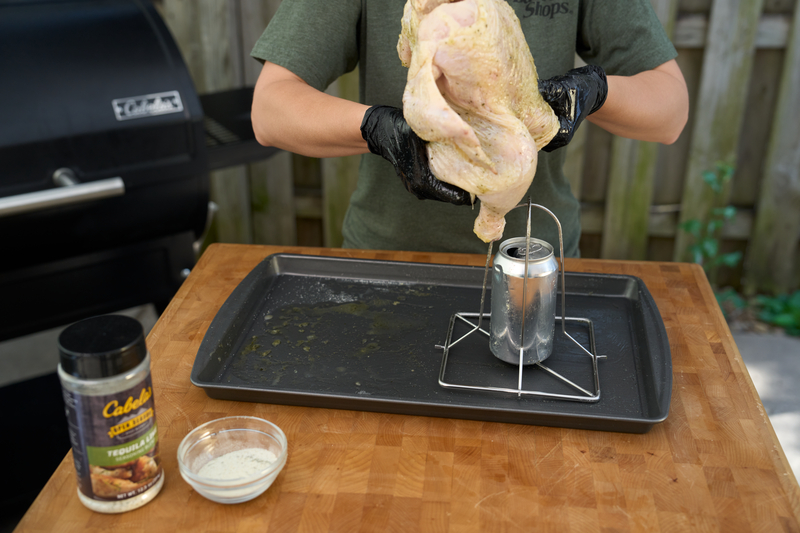placing chicken on beer can chicken mount