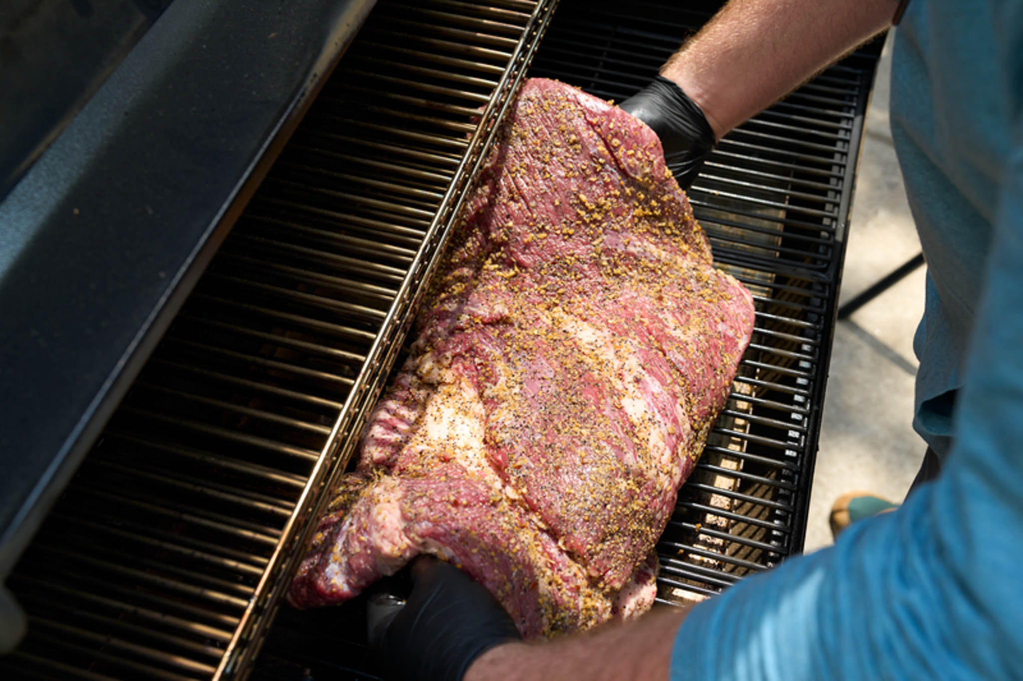 Placing brisket on grill