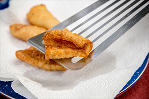 Fried fish resting on paper towel