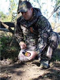 hunter spreading deer scrape scent