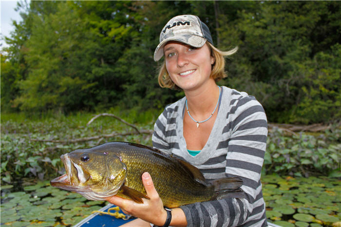 Lady angler holding a large bass