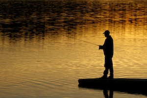 Fishing on a dock at sunset