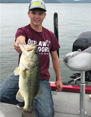 Young angler holding a largemouth bass on Kentucky lake