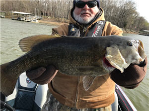Angler on Kentucky Lake holding a smallmouth bass