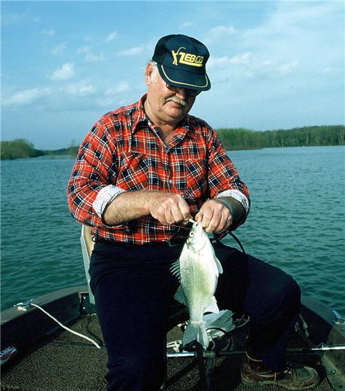 White bass angler un-hooking his catch