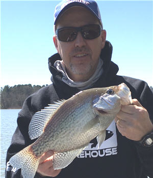 Angler holding up a large black crappie
