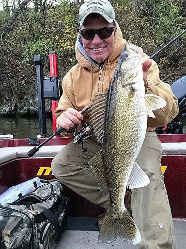 Eric Olson, fishing pro holding up a fine river walleye he caught