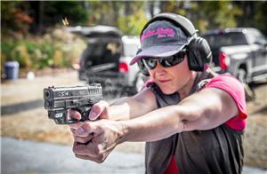 Lady shooting a pistol for practice