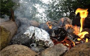 Foil pack food cooking in a campfire