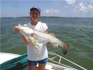 Girl holding snook fish