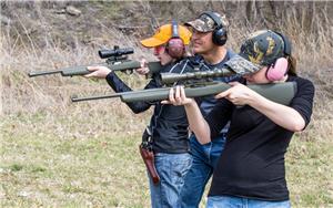 Young shooters practice shooting rifles