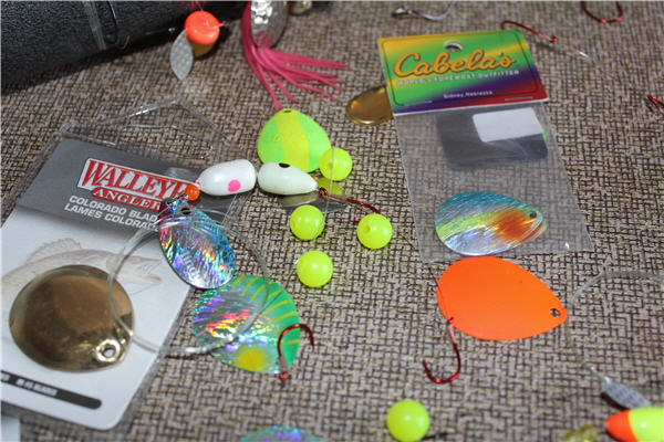 several spinners blade-baits, brands from Walleye Angler and Cabela's laying on a table