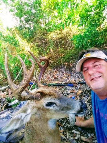 Florida deer hunter posing with his harvested buck