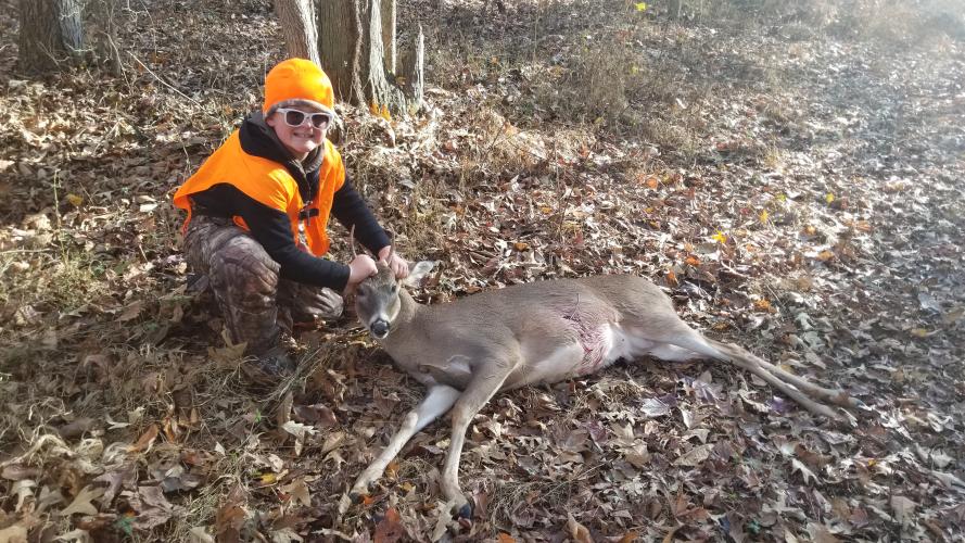 Young deer hunter with his whitetail