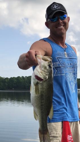 Angler on a lake catching nice bass