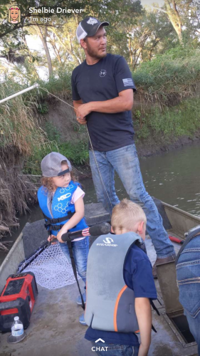Father and two children fishing on the river