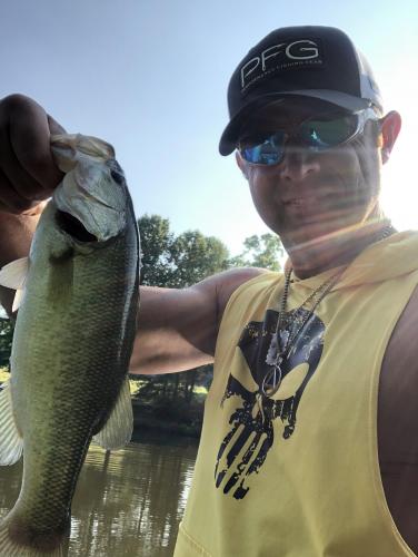 Angler holding his bass fish by the lip