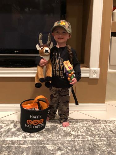 Young boy toddler with toy deer at the holloween event, Bass Pro Ft. Myers