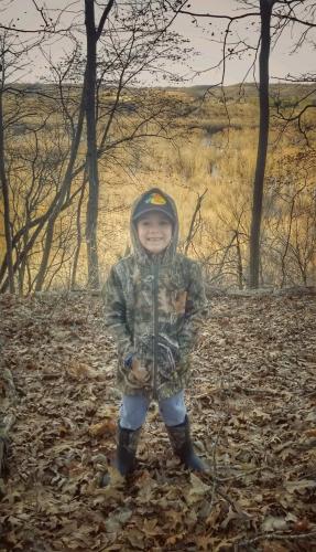 Young boy in camo jacket in the outdoors