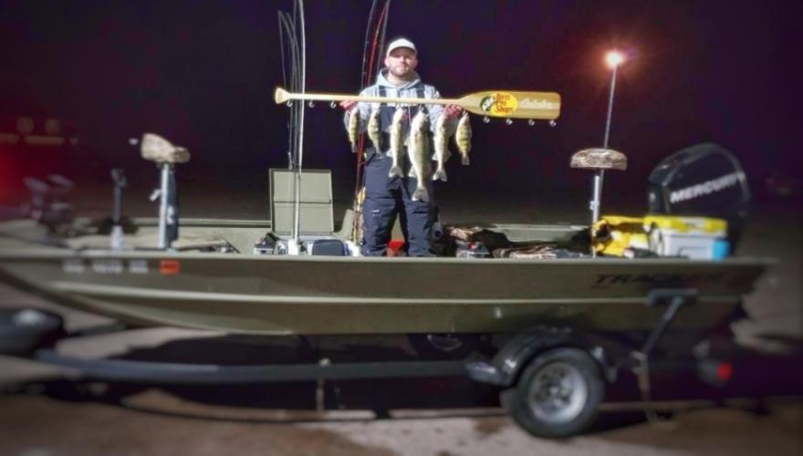 Angler in his fishing boat at night parked on a lot