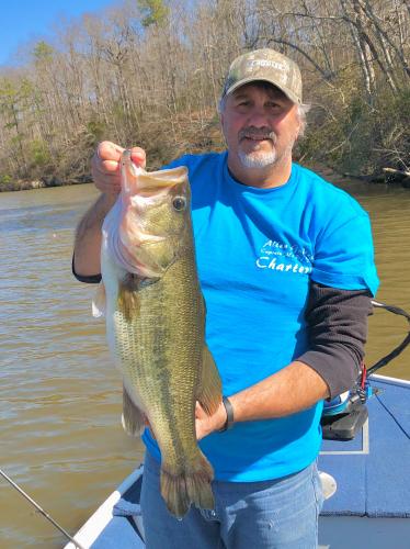 Angler holding  a 9 lb Largemouth Bass