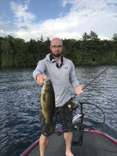 Angler holding a nice catch from a bass boat