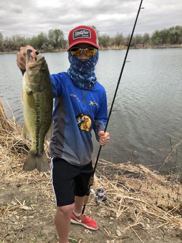 Boy angler holding bass