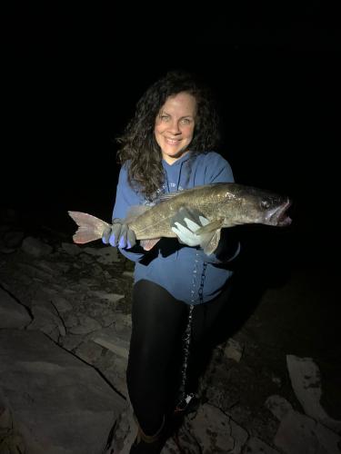 Lady angler carrying walleye