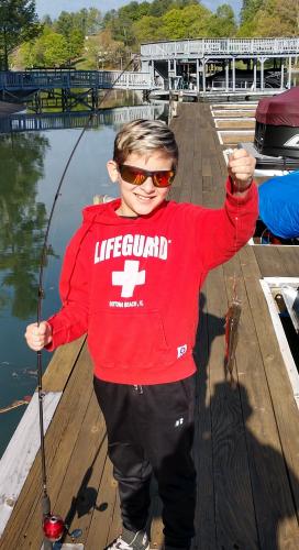 Boy angler fishing off a dock