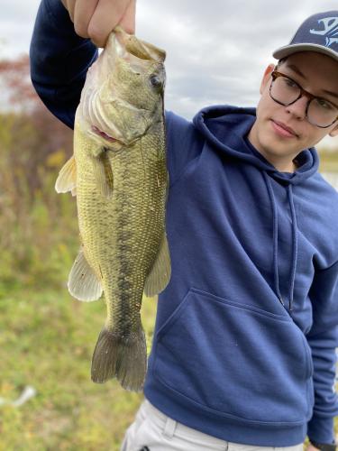 Young angler with bass