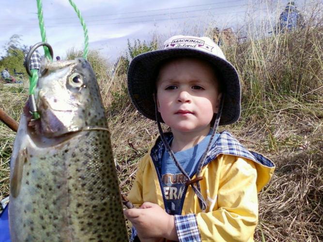 Young boy holds up a stringer of Pink salmon caught from the ocean