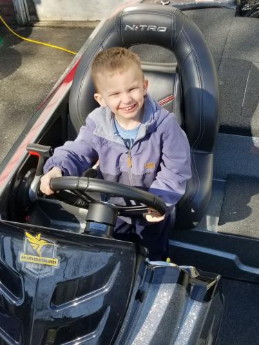 Young boy sitting in a nitro boat