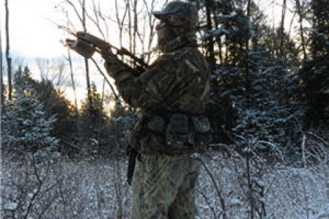 Hunter with bow in the snow