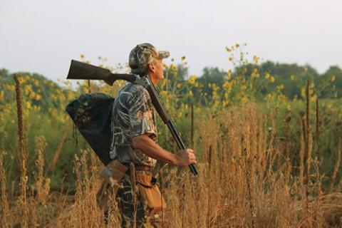 Hunter holding shotgun 