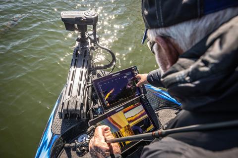 Fisherman reading Humminbird sonar on boat