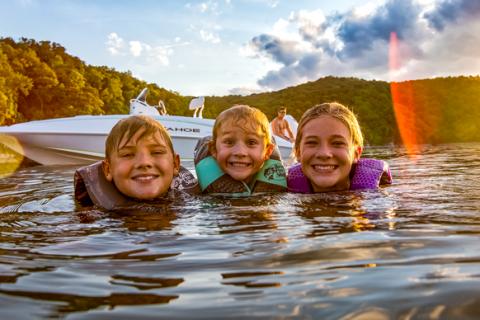 Three Kids Swimming from Tahoe Boat