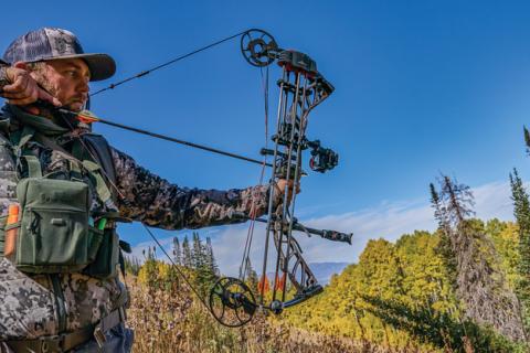 hunter draws blackout compound bow on elk hunt