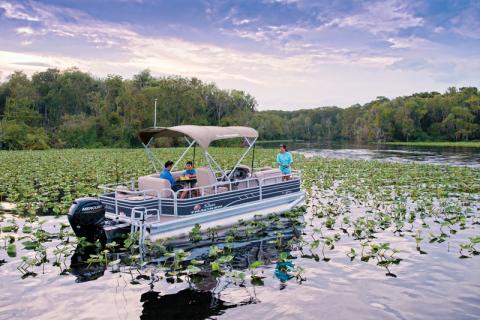 Family enjoying their pontoon boat on the water