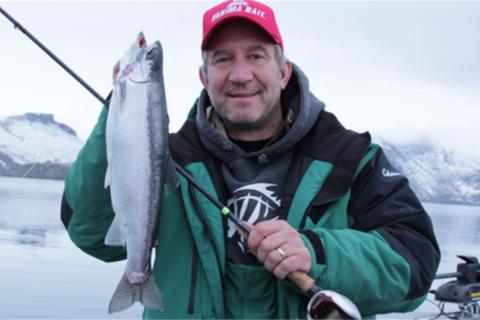 Winter time angler holding a trout