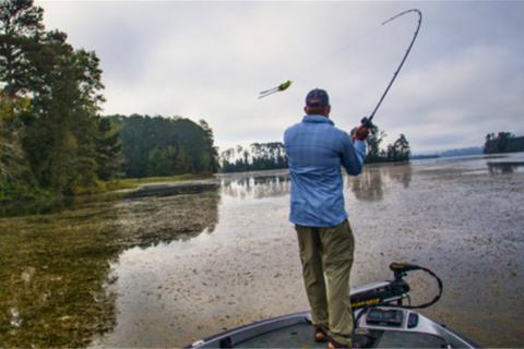 Angler casting a frog bait