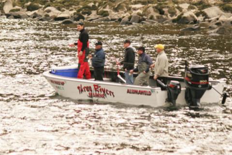 Angler in a deep v-bottom boat fishing for steelhead