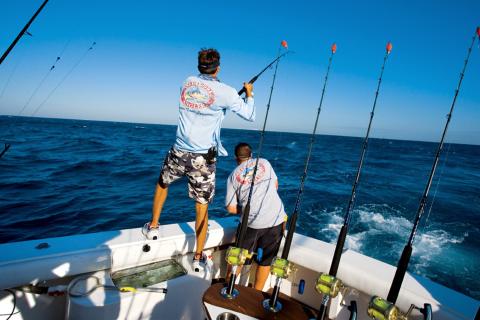 2 saltwater anglers fishing from boat