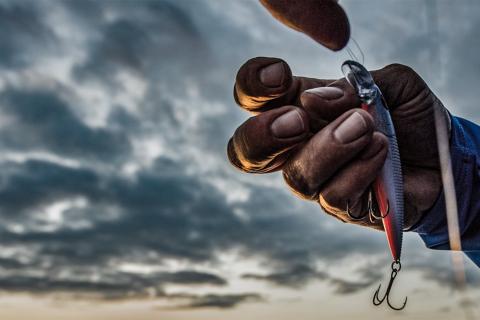 Hand holding a rapala lure