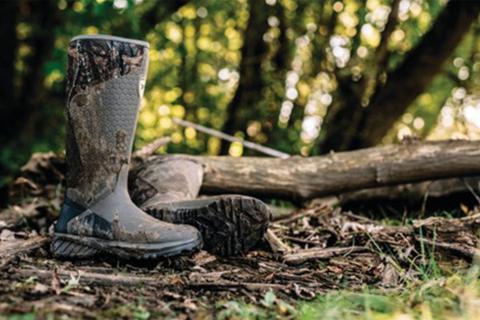 rubber boots next to tree